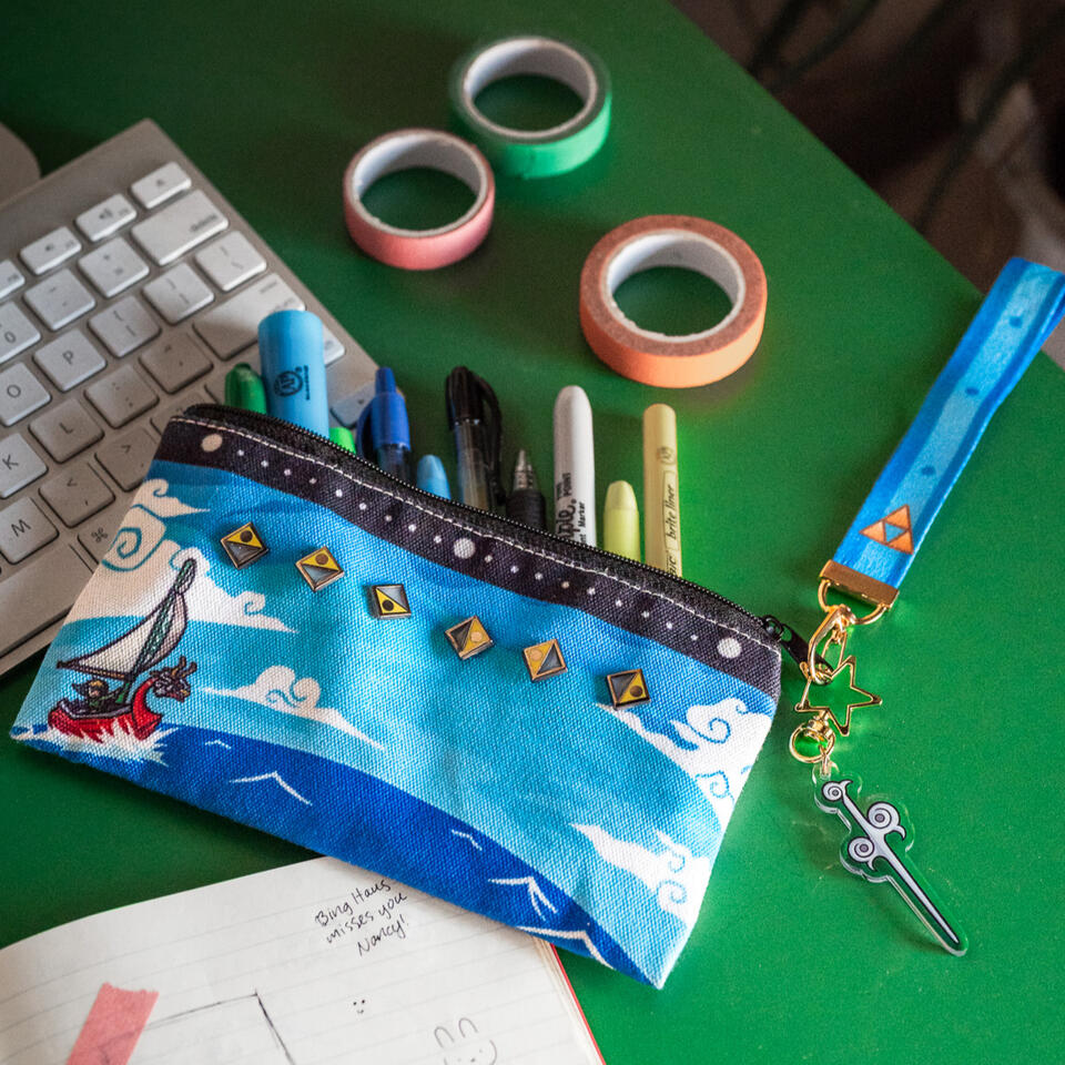 LoZ WW Music Set featuring a themed pencil pouch, lanyard with charm, and enamel pins
